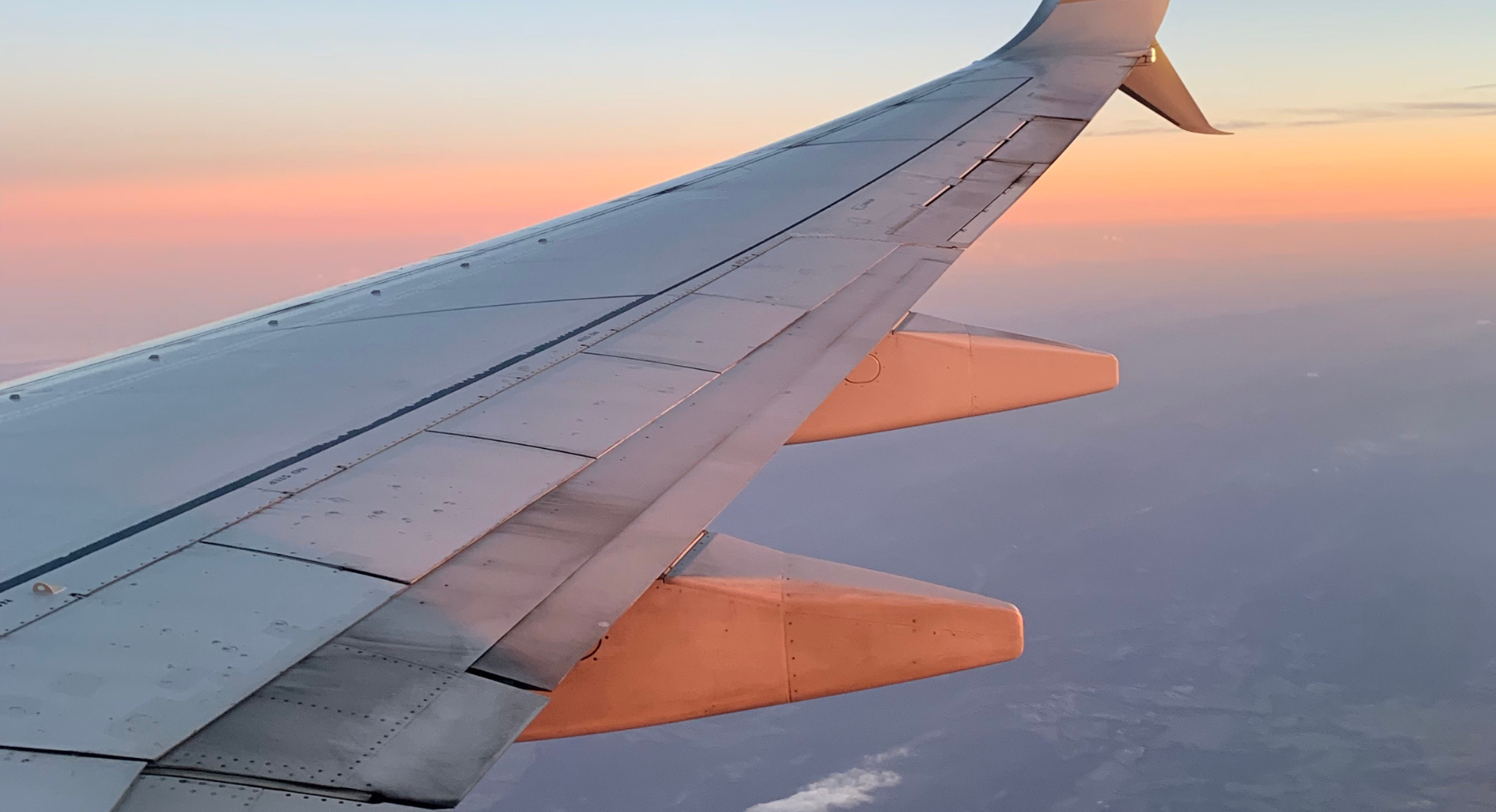 Photo of airplane wing in the sky